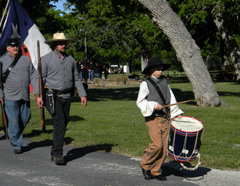 Young boy beating drum leads the parade