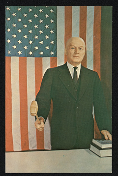Wax figure of Sam Rayburn with gavel and US flag in background