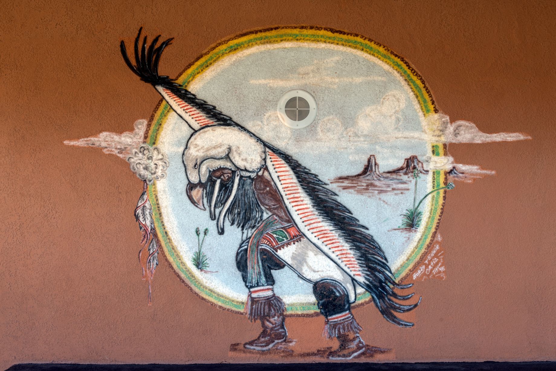 Mural of a Tigua dancer wearing a headpiece and cape like an eagle