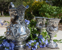 Silver pitcher and goblets.