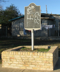 Historical marker with graffiti 