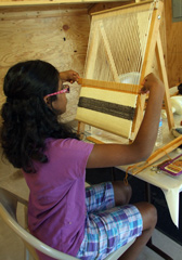 Young girl weaving.