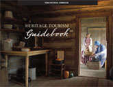Cover of the Heritage Tourism Guidebook showing the interior of a log cabin