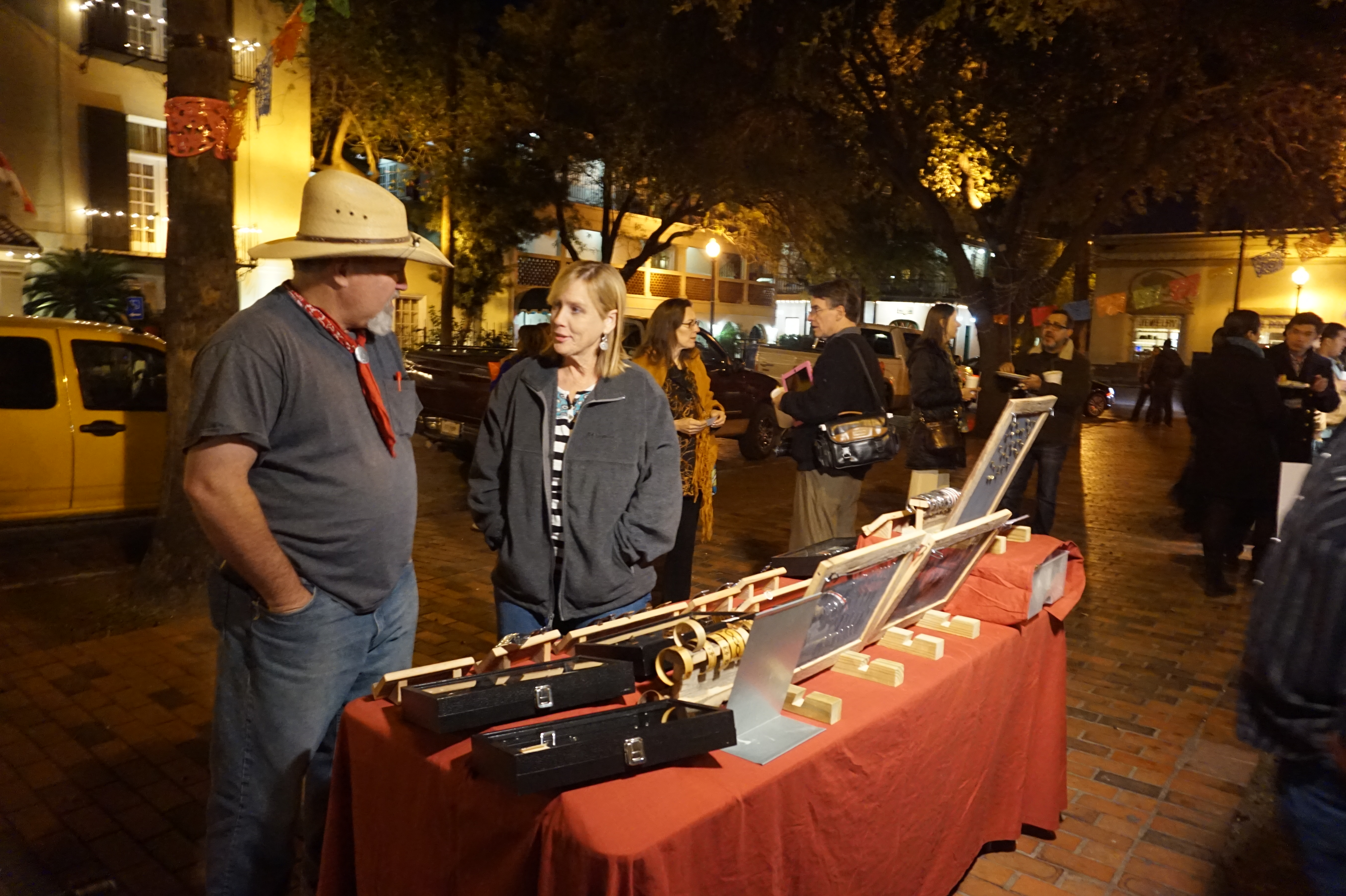 Merchants talking to each other at a night market in Laredo. 