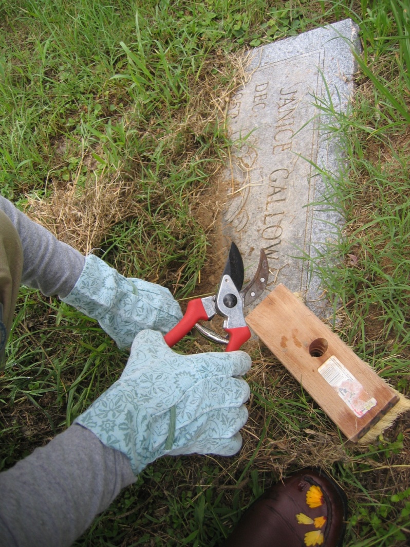 An historic headstone is cleaned.