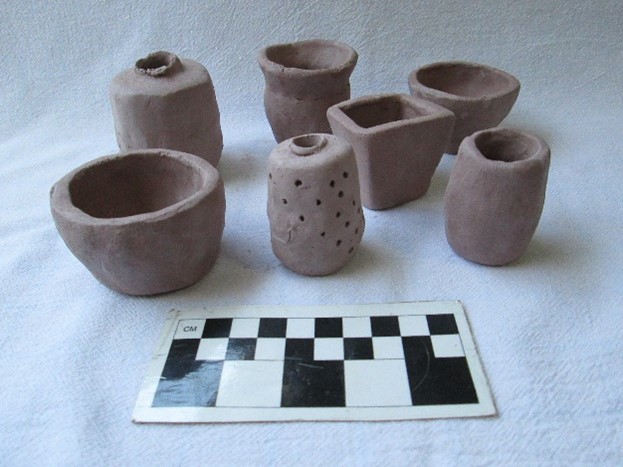Clay pots in front of a checkerboard grid