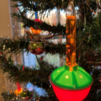 Close-up of bubble light ornament on tree.