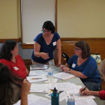 Image of Erin MacEntee leading museum workshop participants through a workshkop activity.