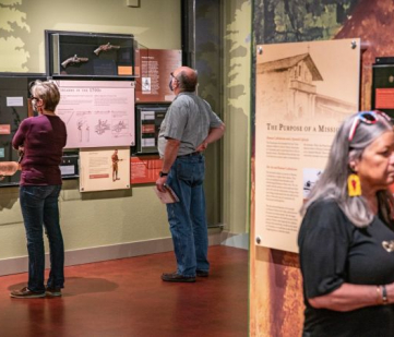 Visitors viewing exhibit at Mission Dolores Museum